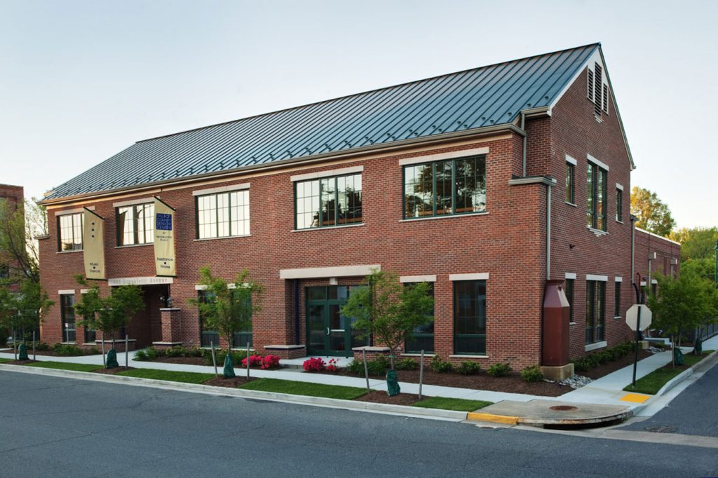 A Willow Construction brick building with a metal roof.